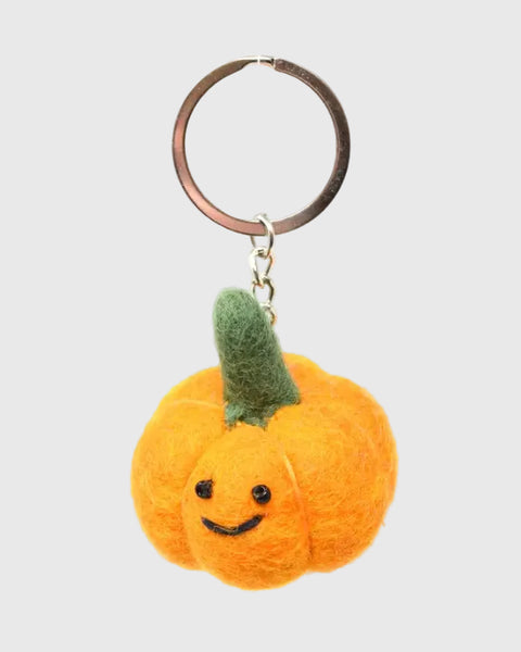 Pumpkin-shaped keychain with a smiley face on a white background