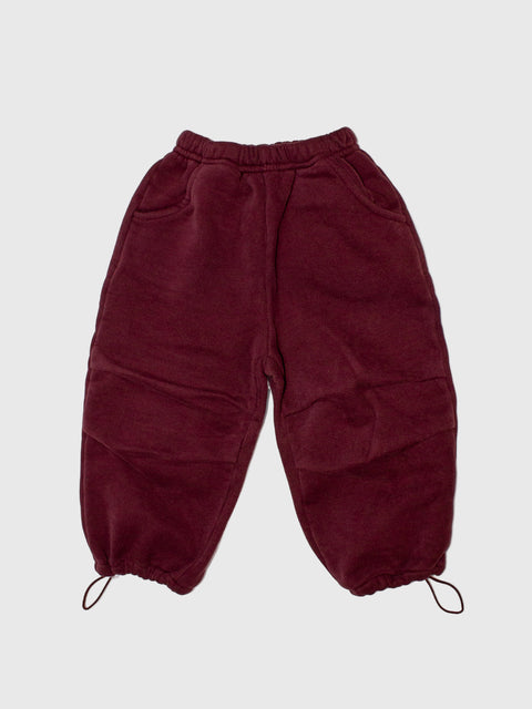 Maroon pants on a light gray background