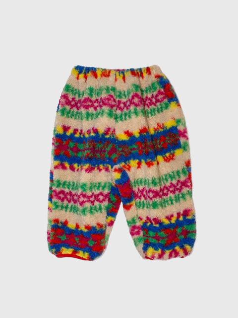 Colorful knitted baby pants on a white background
