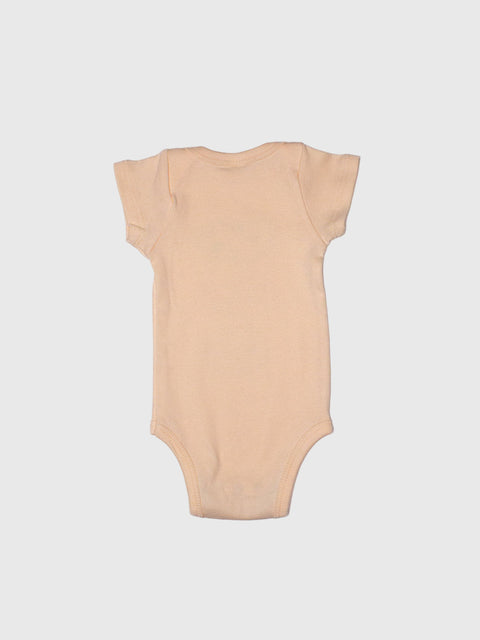 Beige baby onesie on a light gray background