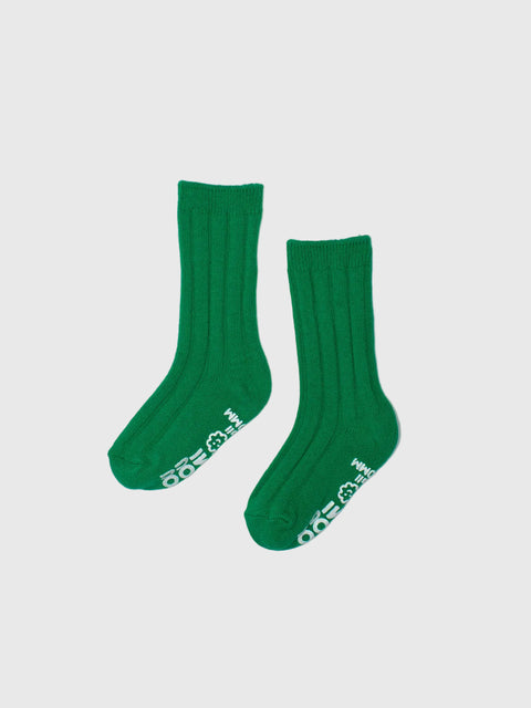 Pair of green socks with white text on a light gray background