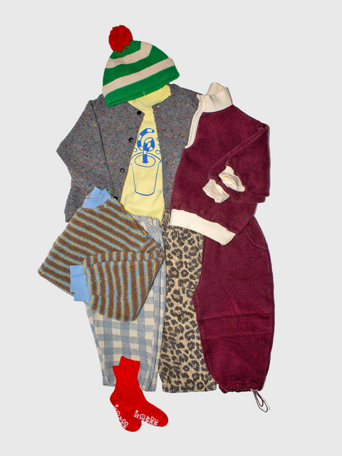 Collection of clothing items including a coat, pants, a hat, and socks on a light gray background