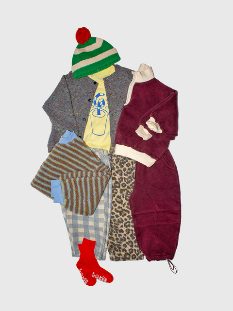 Collection of clothing items including a coat, pants, a hat, and socks on a light gray background