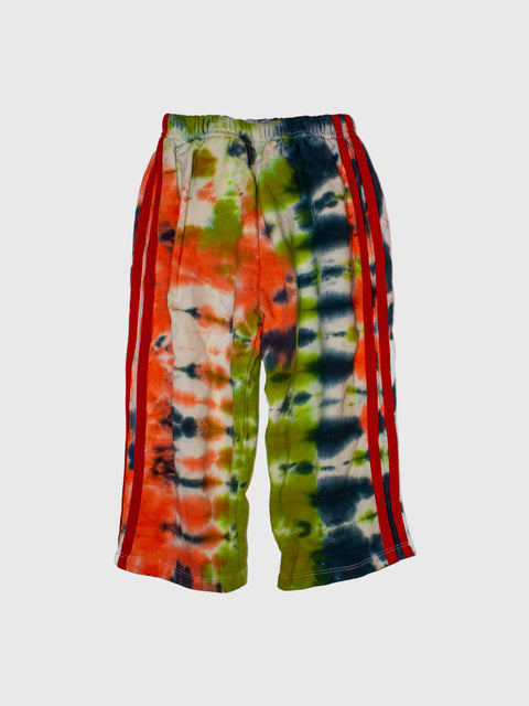 Tie-dye pants with red, green, and blue patterns on a white background
